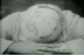Screenshot from Le Rêve des Marmitons showing a face drawn on a bald head.