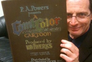 Jerry Beck examines the prop book used as the titles in many of the latter ComiColor cartoons (The book courtesy of, and photo shot by, Mike Van Eaton)