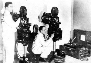 Photograph showing a suit case projectionist set up for non-theatrical screenings.